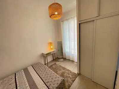 a small bedroom with a bed and a window at Nice Renting - Penchienatti - Spacious Apartment - 2 BedRooms - King Bed - View Heart of Nice in Nice