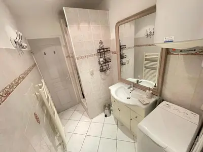 a bathroom with a sink and a toilet and a mirror at Nice Renting - 9 MASSENA - Spacious apartment Massena Square - AC - fully equipped in Nice