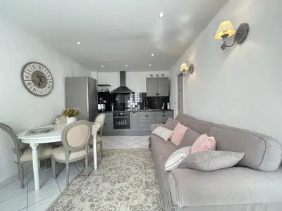 a living room with a couch and a table and a kitchen at Nice Renting - 9 MASSENA - Spacious apartment Massena Square - AC - fully equipped in Nice