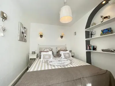 a small bedroom with a bed and shelves at Nice Renting - 9 MASSENA - Spacious apartment Massena Square - AC - fully equipped in Nice