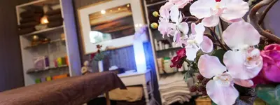 a vase filled with pink flowers in a room at Harmonice in Cantaron