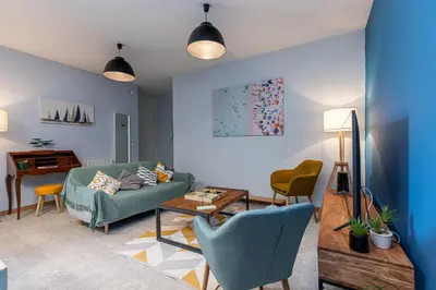 a living room with a couch and chairs and a table at Large 3 Bdr City Center in Nice