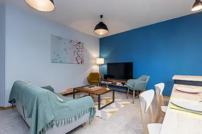 a living room with blue walls and a table and chairs at Large 3 Bdr City Center in Nice