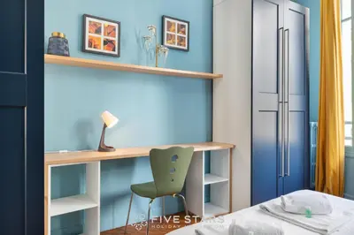 a bedroom with a desk and a chair at Suite Alsace Lorraine FSHH in Nice