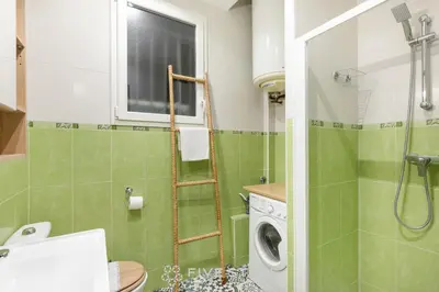 a bathroom with a shower and a washing machine at Suite Alsace Lorraine FSHH in Nice