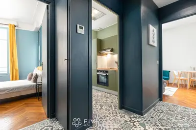 a room with a door open to a kitchen with a bed at Suite Alsace Lorraine FSHH in Nice