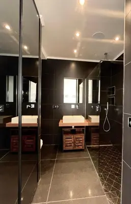 a large bathroom with two sinks and a shower at SEA VIEW TOP FLOOR - PROMENADE DES ANGLAIS in Nice