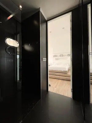 a hallway with a mirror and a bed in a room at SEA VIEW TOP FLOOR - PROMENADE DES ANGLAIS in Nice