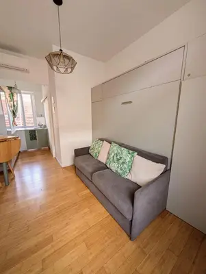 a living room with a couch and a table at Herold Riviera in Nice