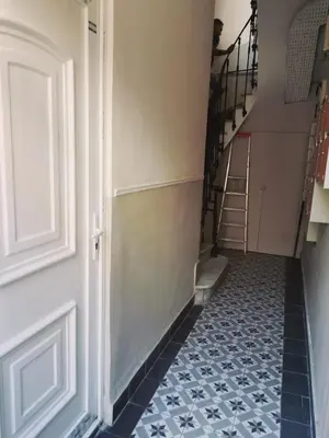 a hallway with a staircase with blue and white tiles at Herold Riviera in Nice