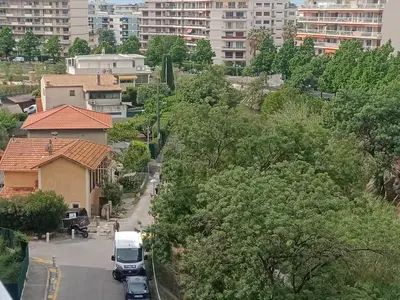 a city street with a white van parked in front of buildings at Provencal in Cagnes-sur-Mer