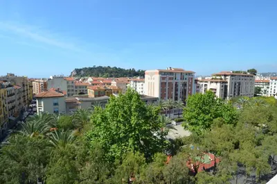 a view of a city with trees and buildings at HELIANTHE - Superbe appartement avec terrasse vue mer et Château au Port de Nice in Nice