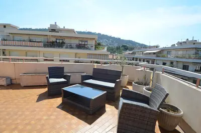 a patio with chairs and a table on a balcony at HELIANTHE - Superbe appartement avec terrasse vue mer et Château au Port de Nice in Nice