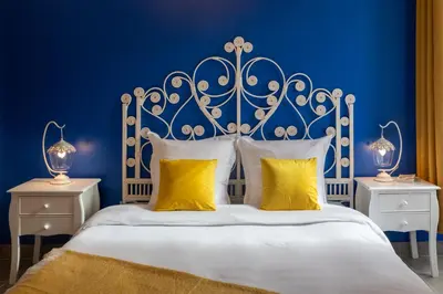 a blue bedroom with a white bed with yellow pillows at Lovely apartment with terrace Nice centre in Nice