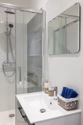 a white bathroom with a sink and a shower at Lovely apartment with terrace Nice centre in Nice