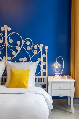 a blue bedroom with a white bed and a yellow pillow at Lovely apartment with terrace Nice centre in Nice