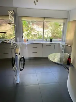 a kitchen with a sink and a washing machine at Appartement en résidence avec piscine in Nice