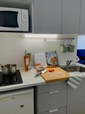 a kitchen counter with a cutting board and a microwave at AM STUDIO NICE in Nice
