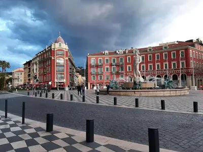 a city square with a statue in front of buildings at AM STUDIO NICE in Nice