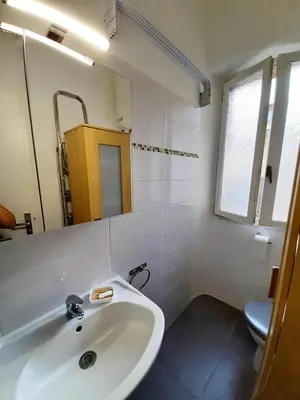 a white bathroom with a sink and a mirror at AM STUDIO NICE in Nice