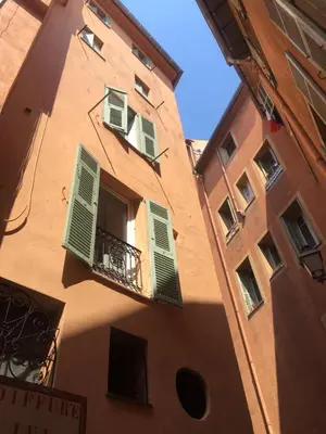a building with green shutters and a balcony at PRIVATE BUILDING, 4 APTS, UNIQUE AT NICE- OLD TOWN in Nice