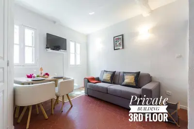 a living room with a couch and a table at PRIVATE BUILDING, 4 APTS, UNIQUE AT NICE- OLD TOWN in Nice