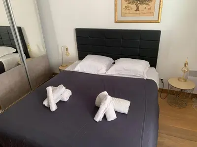 two towels on a bed in a bedroom at Chez Chebil in rue Halevy - near the sea in Nice