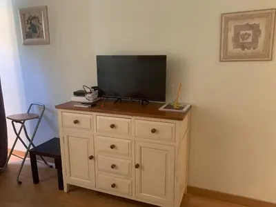 a white dresser with a television on top of it at Chez Chebil in rue Halevy - near the sea in Nice