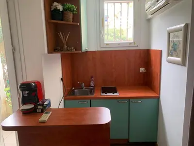 a small kitchen with a sink and a counter at Chez Chebil in rue Halevy - near the sea in Nice