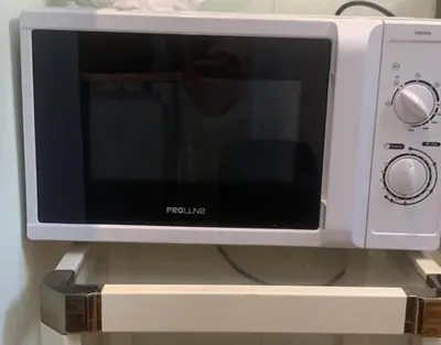 a microwave sitting on top of a shelf at Chez Chebil in rue Halevy - near the sea in Nice