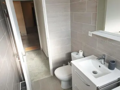a bathroom with a white toilet and a sink at Beautiful T1 with sea view in Nice