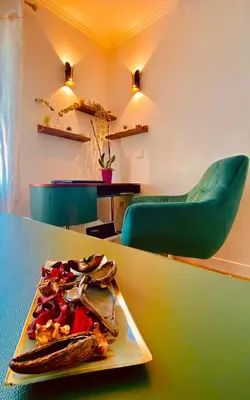 a plate of food on a table with a green chair at Villa Canarias in Saint-Jeannet