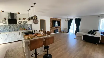 a kitchen and living room with a island in the middle at Villa Canarias in Saint-Jeannet