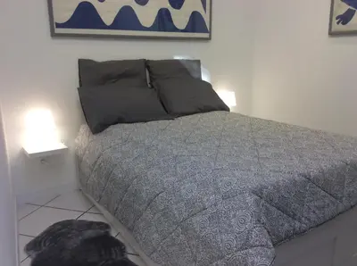 a bedroom with a bed with two lamps on it at Les palmiers in Nice