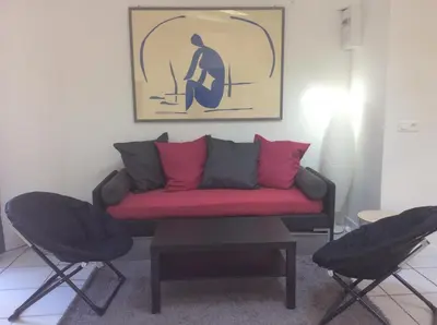 a living room with a couch and two chairs at Les palmiers in Nice