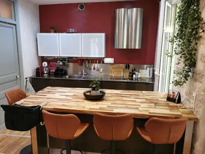a kitchen with a wooden table and chairs at Our home, Cozy Apartment two minutes from the sea - Clima in Nice