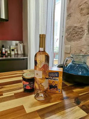 a bottle of alcohol sitting on top of a kitchen counter at Our home, Cozy Apartment two minutes from the sea - Clima in Nice