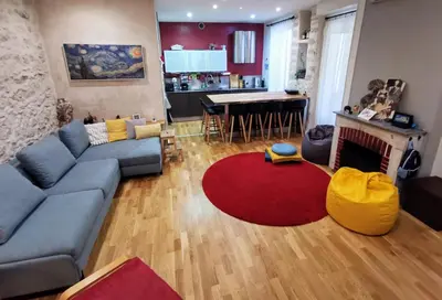 a living room with a blue couch and a red rug at Our home, Cozy Apartment two minutes from the sea - Clima in Nice