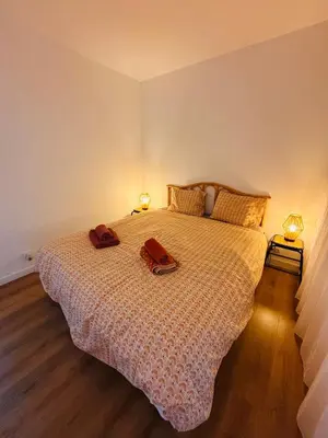 a bedroom with a bed with two towels on it at Plage Landsberg - Saint-Laurent-du-Var in Saint-Laurent-du-Var