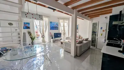 a living room with a glass table and a couch at Stunning Duplex place Masséna 2 mins walk from beaches in Nice