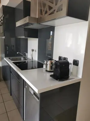 a kitchen with a sink and a counter top at Stunning Duplex place Masséna 2 mins walk from beaches in Nice