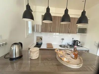 a kitchen with black pendant lights and a counter top at Le 29 Promenade des Anglais - Golden Square in Nice