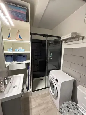 a washing machine in a bathroom with a sink at Le 29 Promenade des Anglais - Golden Square in Nice