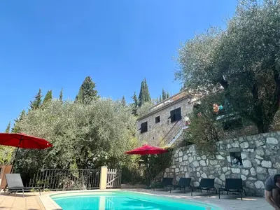 a swimming pool in the middle of a yard with trees at Entre Nice et Monaco grande Villa avec piscine privée 12 personnes in Drap