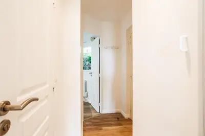 a hallway with a door leading into a room at L'ANGE GARDIEN III AP4293 By Riviera Holiday Homes in Villefranche-sur-Mer