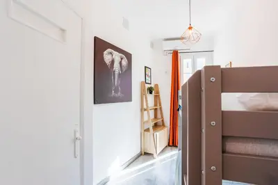 a bedroom with a bed and a staircase with a picture of an elephant at LE TIVOLI II AP4282 By Riviera Holiday Homes in Nice