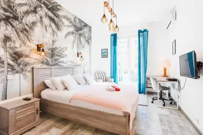 a bedroom with a bed and a desk with a computer at LE TIVOLI II AP4282 By Riviera Holiday Homes in Nice