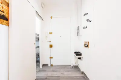 a hallway with white walls and a door at LE TIVOLI II AP4282 By Riviera Holiday Homes in Nice