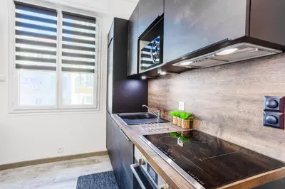 a kitchen with a counter and a sink and a window at LE TIVOLI II AP4282 By Riviera Holiday Homes in Nice