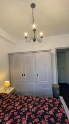 a bedroom with a bed and a chandelier at Appartement entier. Nice Riquier in Nice